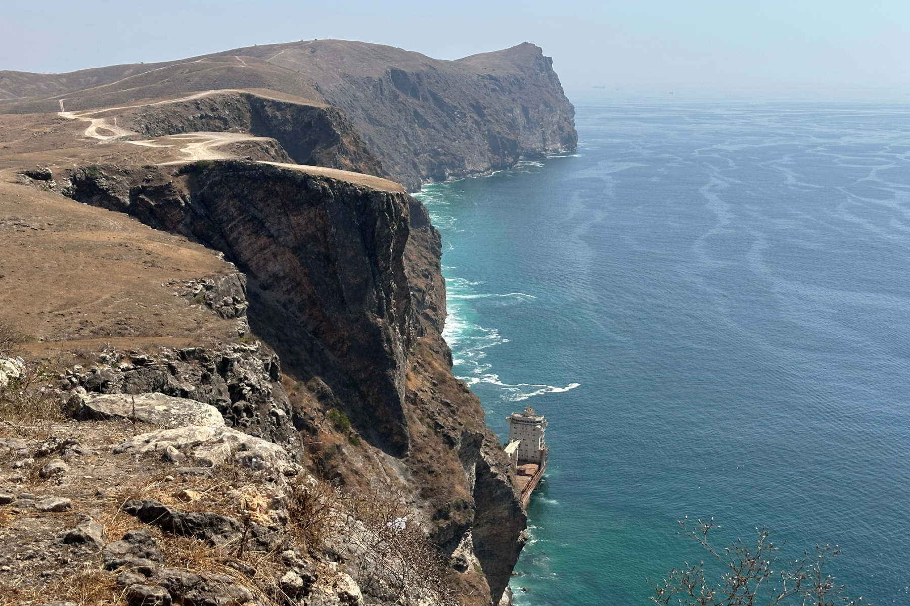 Avew from the top of the cliffs at Iftalqoot looking down at the wreck of the container ship MV Jernas