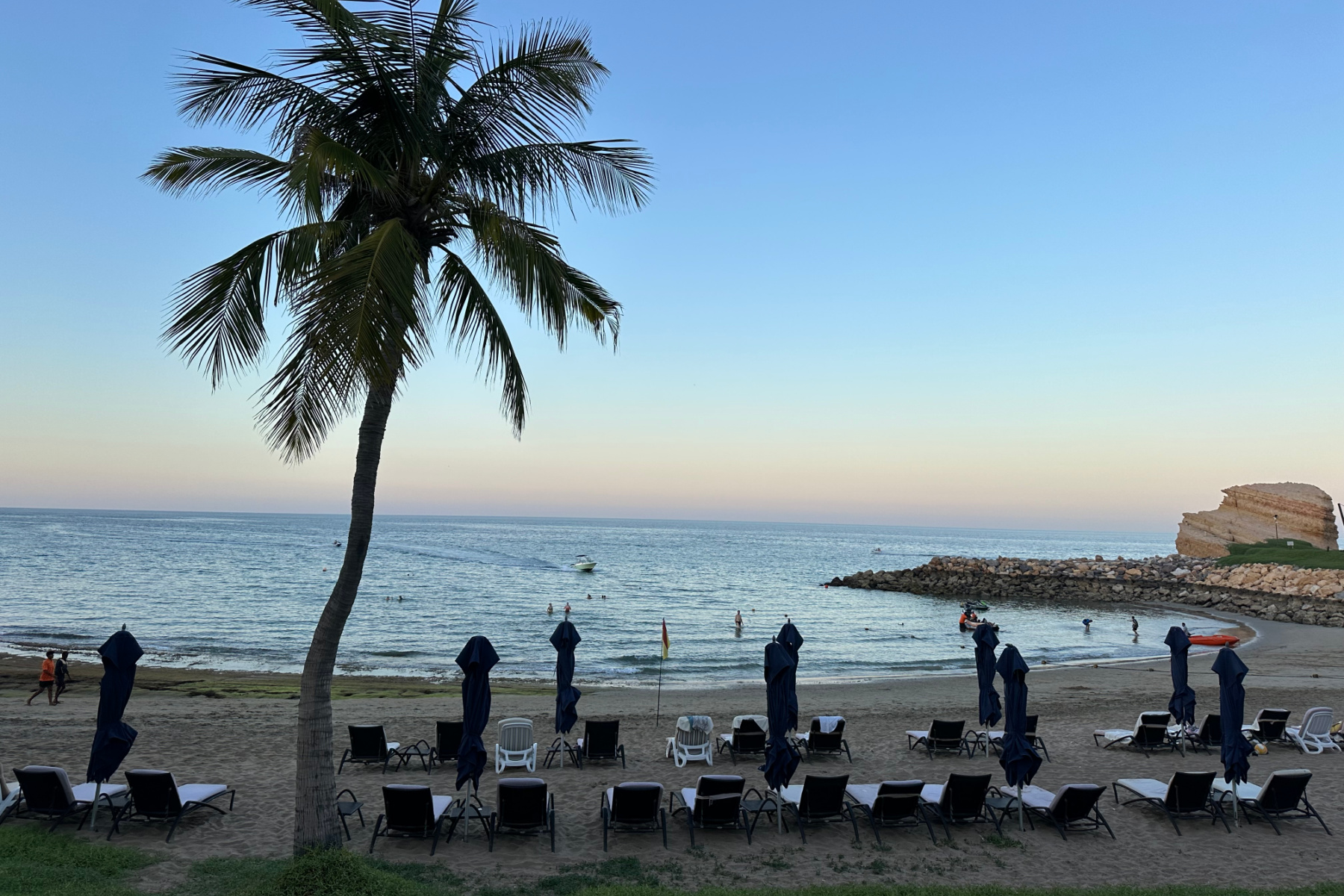 Sun beds on the beach in front of the Al Waha hotel