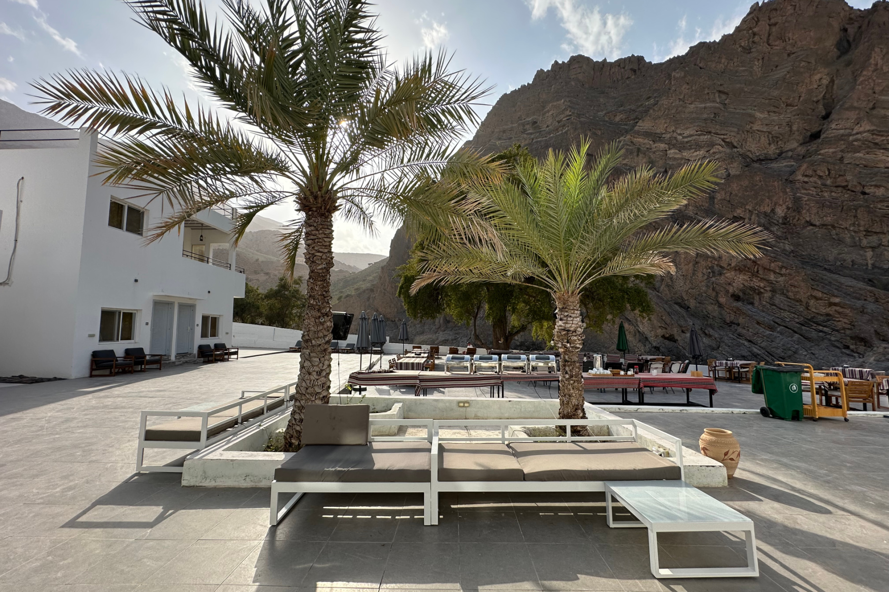 The central terrace at the resort with seating and palm trees