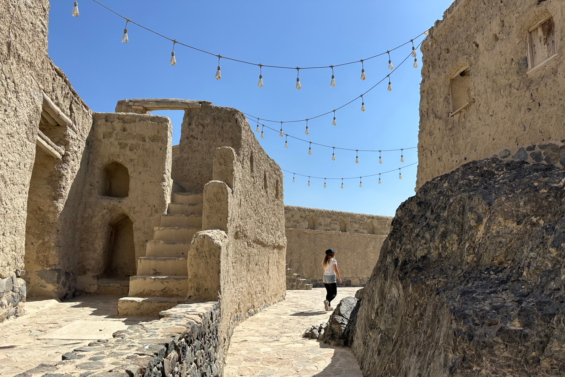 My daughter walking between the walls at Bahla Fort