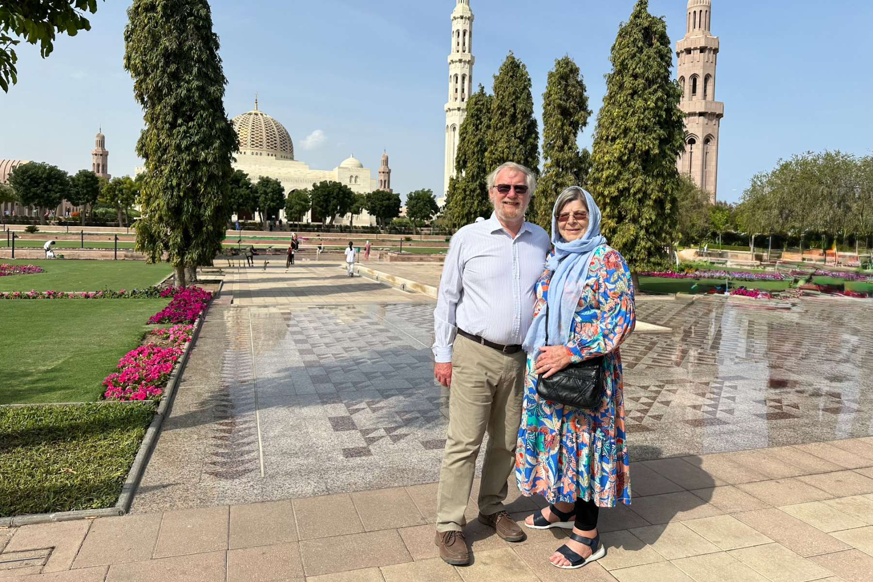 My in-laws stood just inside the entrance to the Grand Mosque with the gardens and mosque dome behind them