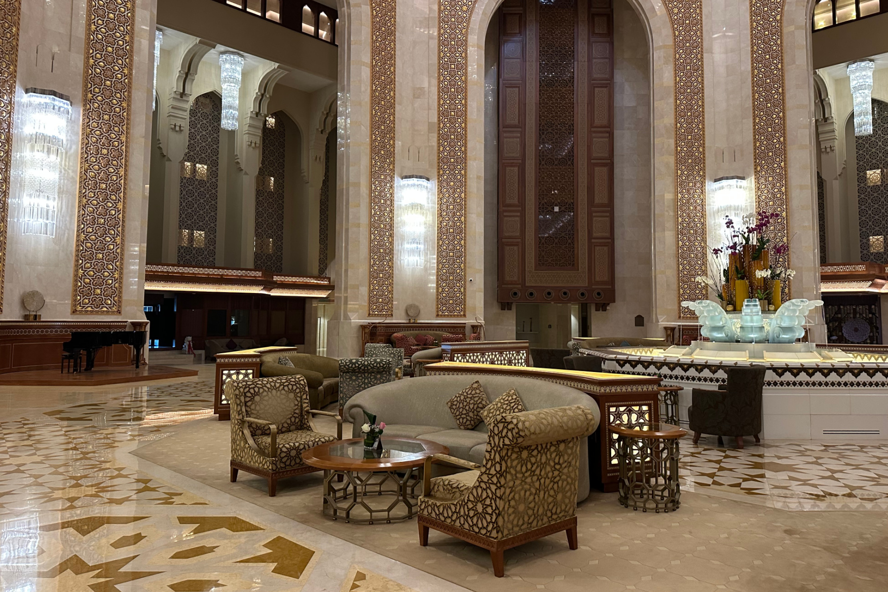 The hotel lobby The walls are covered in Arabic tiles, the floor is marble and the furniture looks like it has been designed for royalty