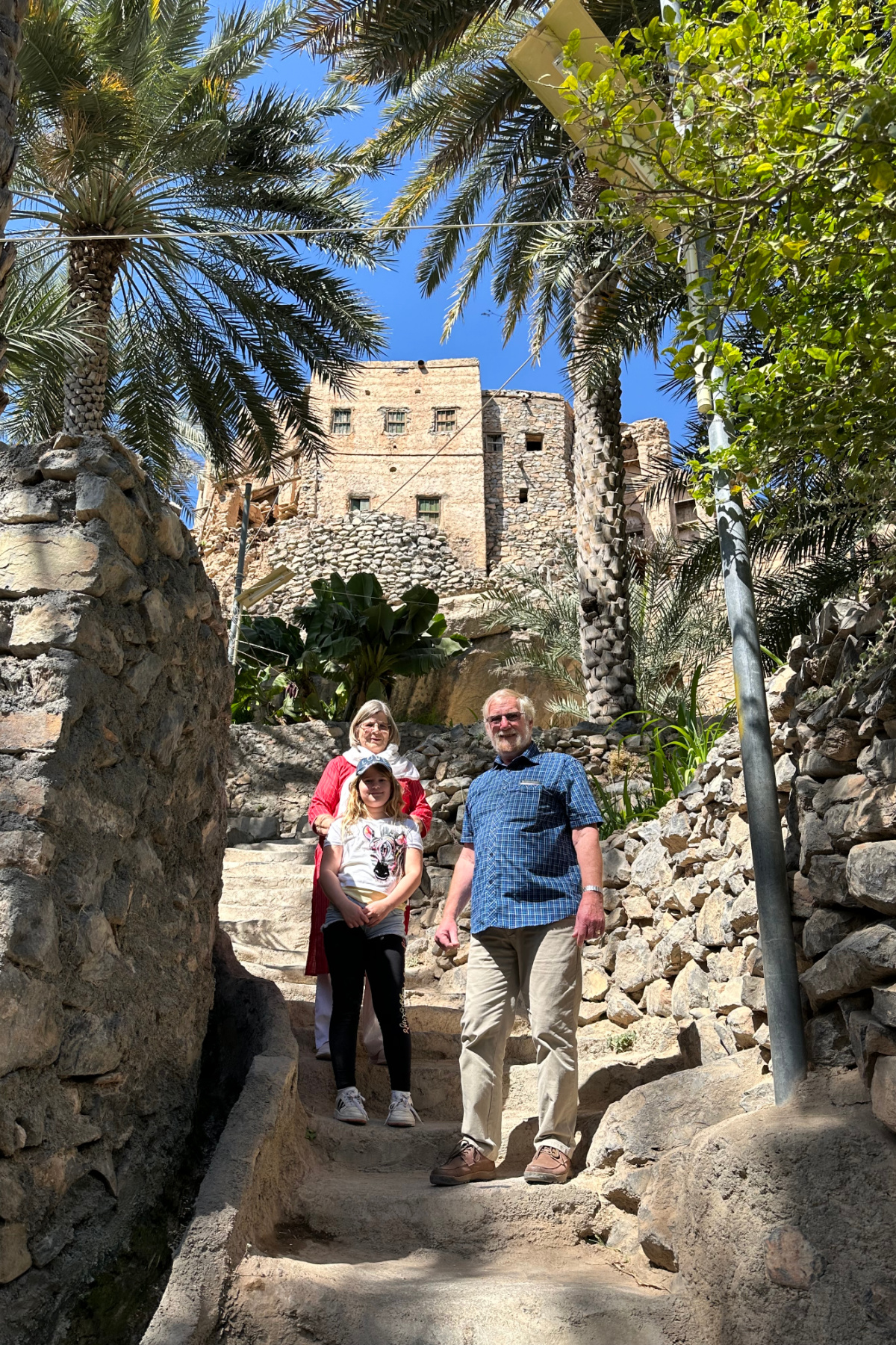 My in-laws and daughter stood on uneven steps in the plantations of the mountain village of Misfat Al Abriyeen