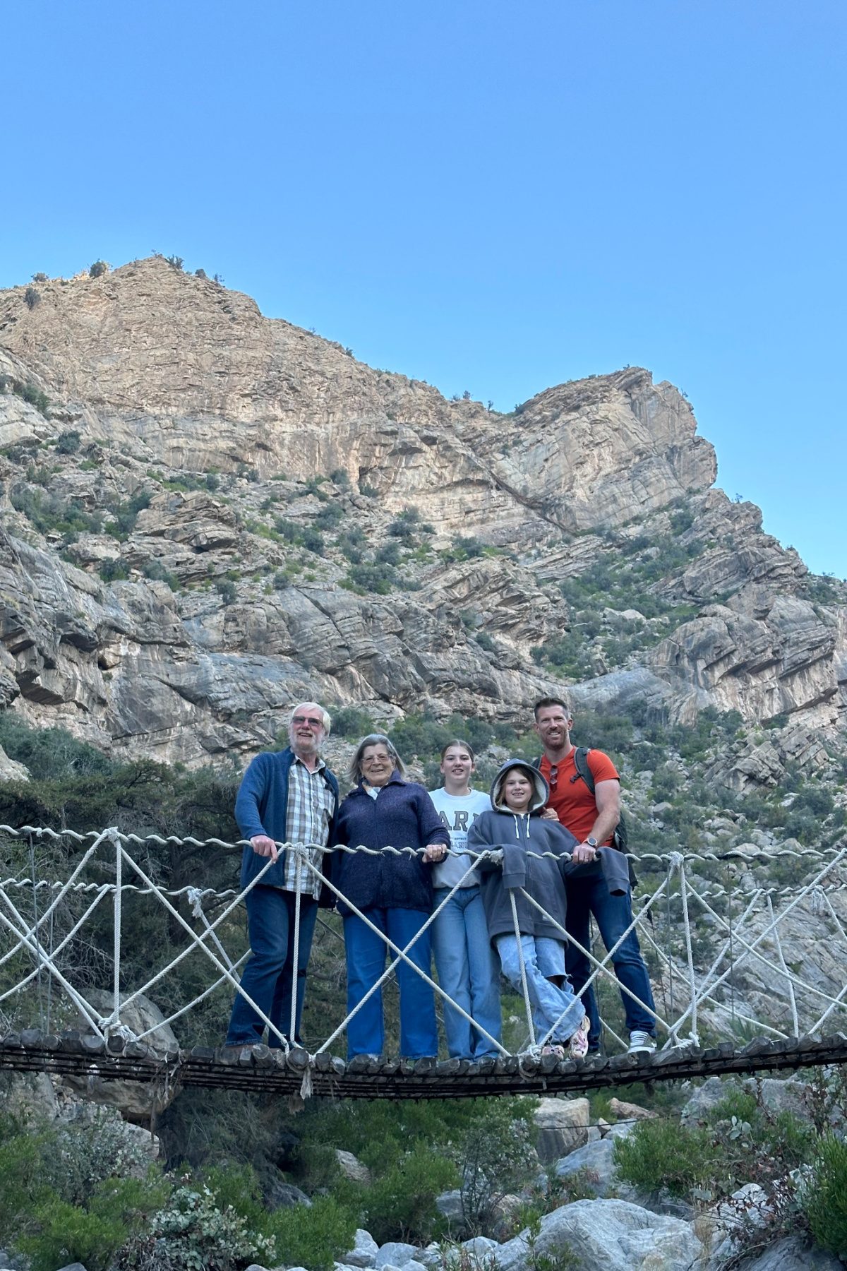 My husband, children and in-laws standing on the bridge on the way to The Suwgra on Jebel Akhdar