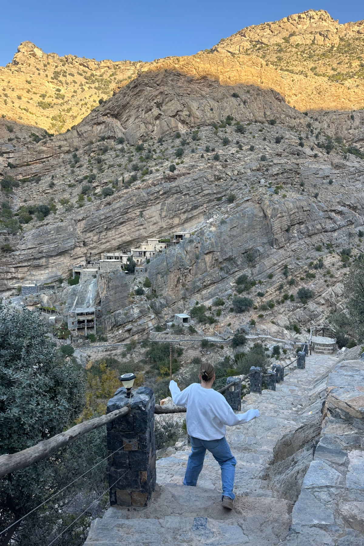 My daughter walking down the uneven steps towards The Suwgra heritage village on Jebel Akhdar