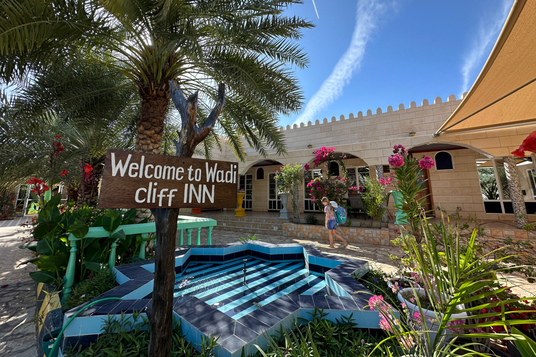 Welcome to Valley Cliff Inn sign in gardens outside villa