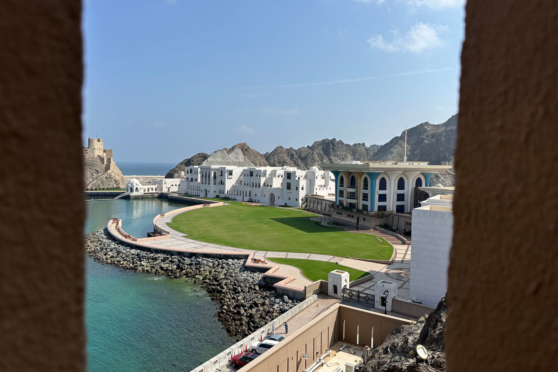 A view of the back of Al Alam Palace and its green lawn facing the Sea of Oman