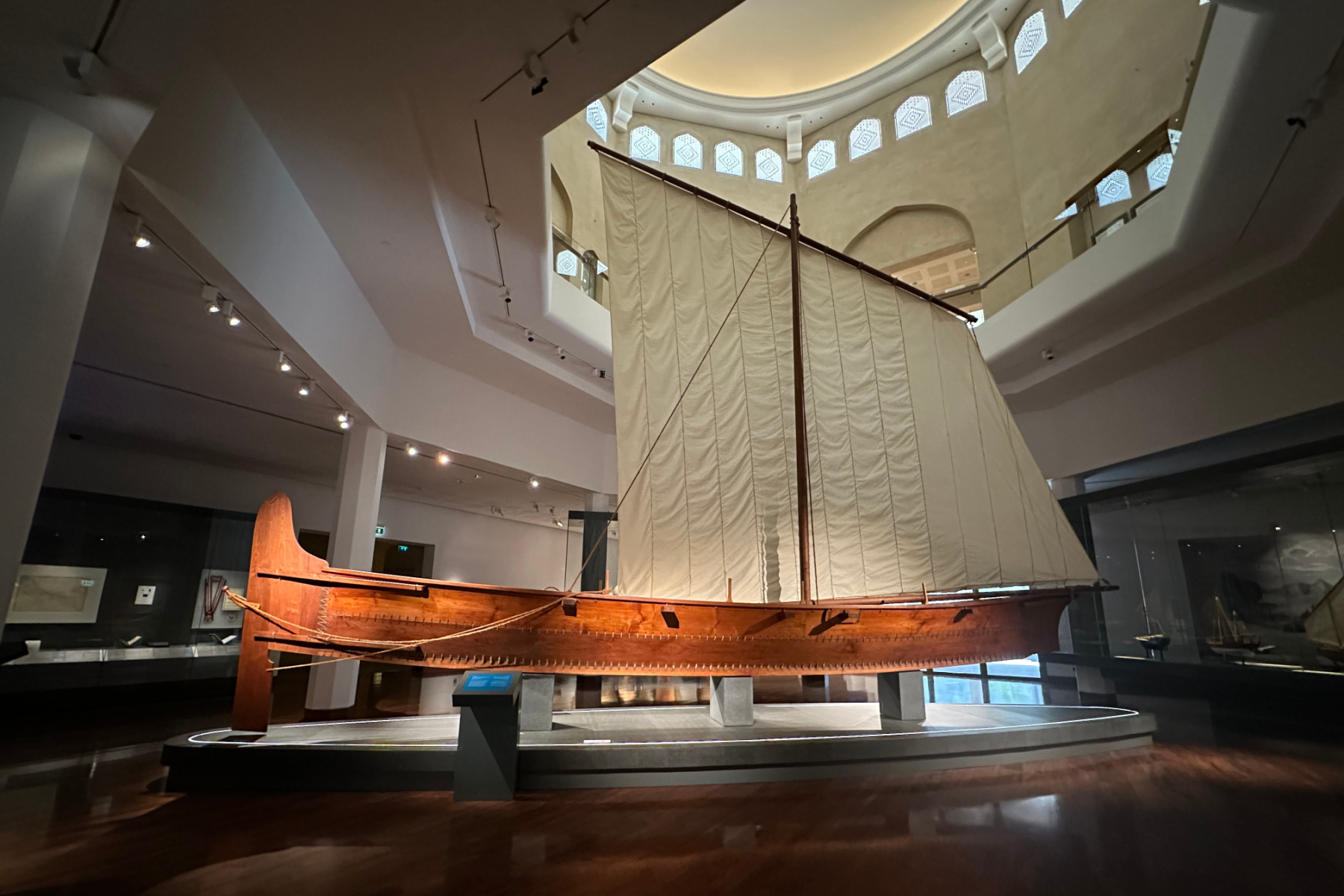 A recreation of a fishing boat from the 19th Century made from teak with a triangle canvas sail