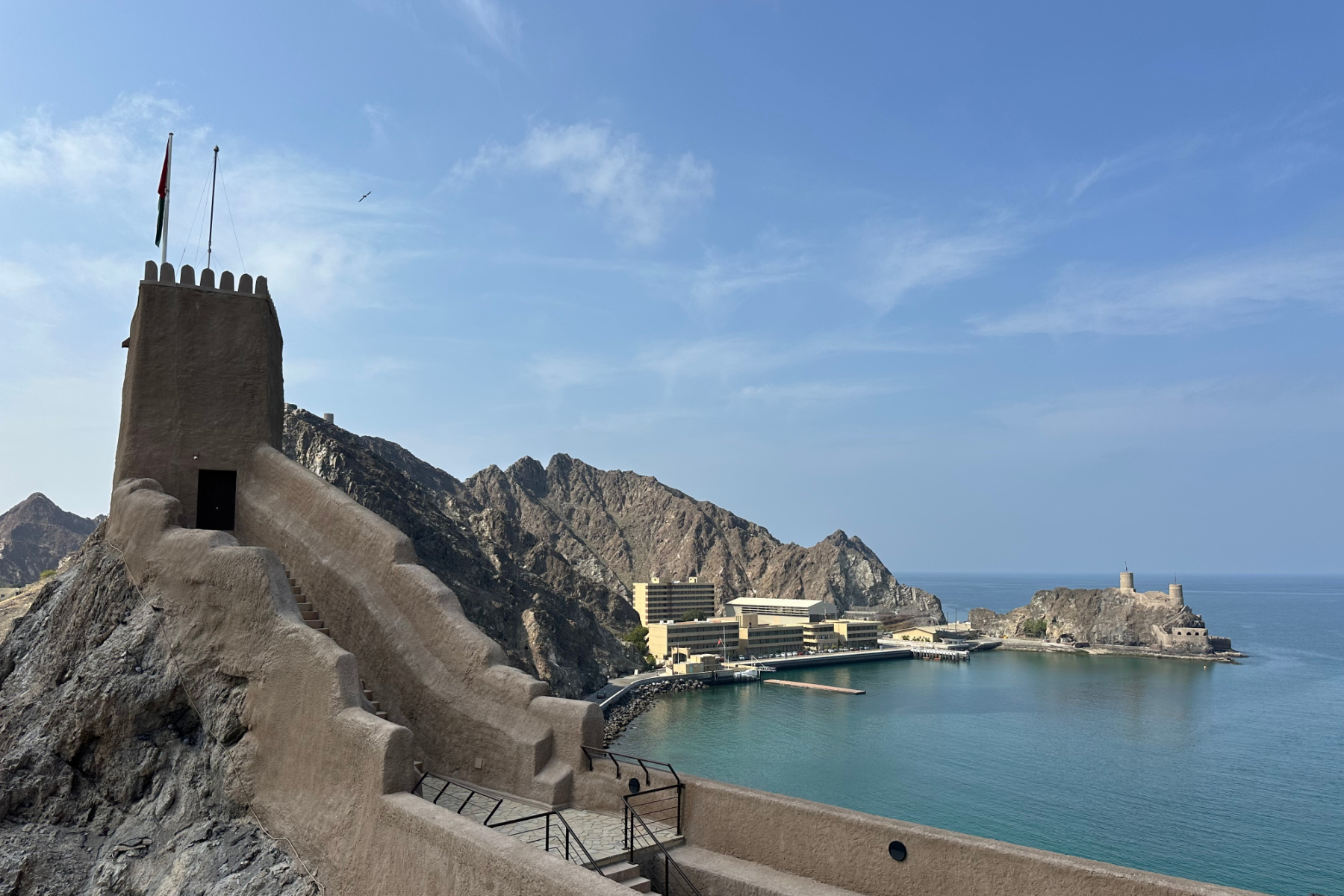 A view north from Al Mirani Fort including one of its towers and an Omani Naval Base