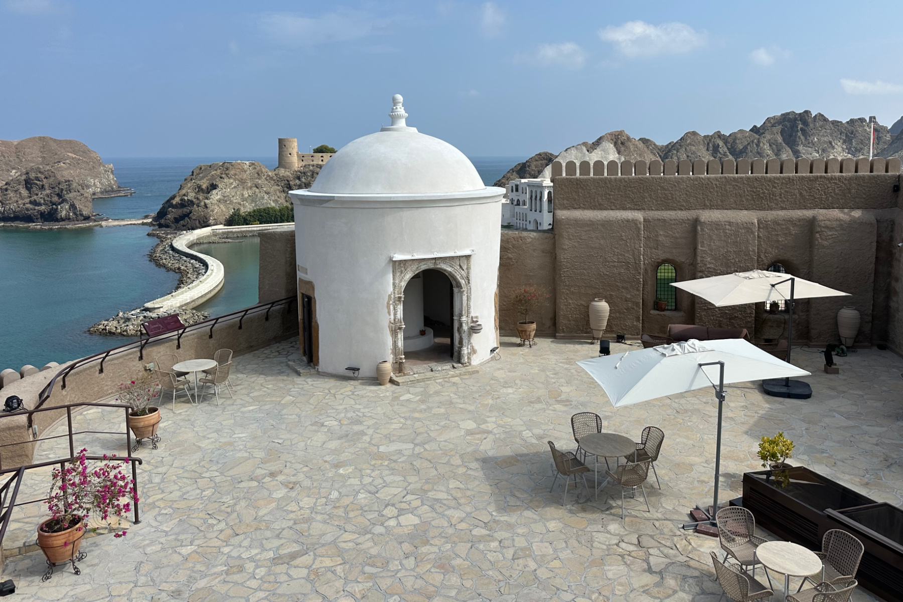 The outside seating area at the top of Al Mirani Fort in Muscat overlooking Al Alam Palace and Al Jalali Fort