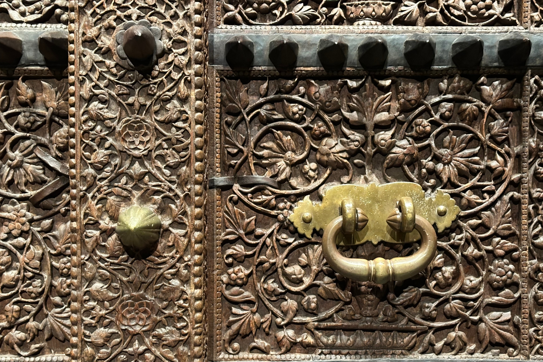 An intricately carved wooden gate that once stood at the entrance of a fort