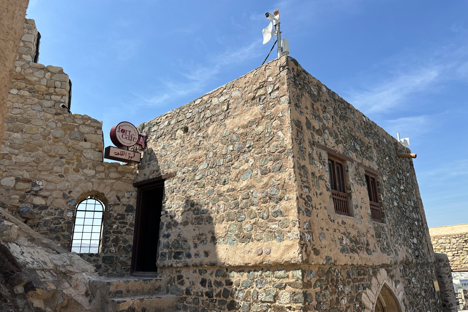 The stone brick exterior of Muttrah Fort's cafe which is on the battlements